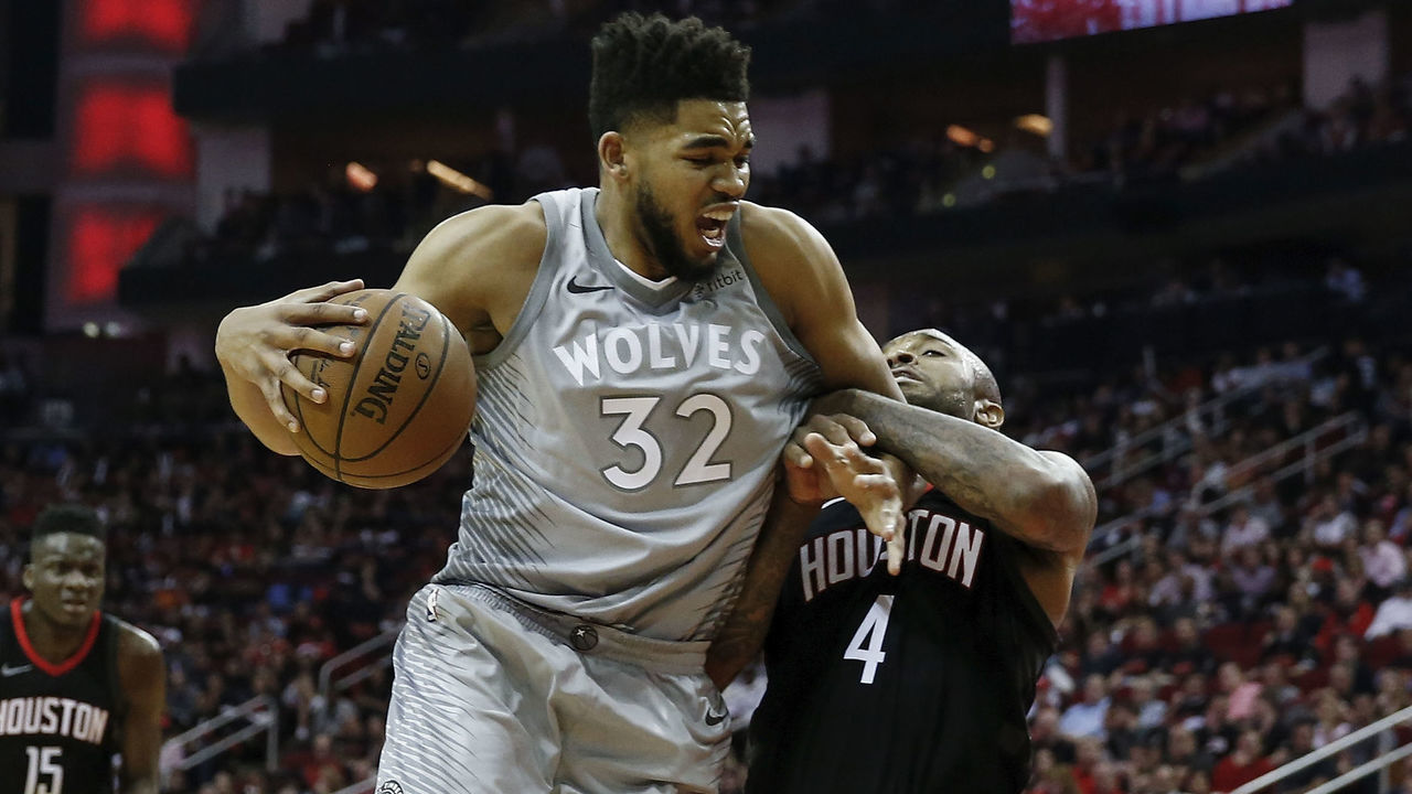 HOUSTON, TX - APRIL 15: Karl-Anthony Towns #32 of the Minnesota Timberwolves drives to the basket defended by PJ Tucker #4 of the Houston Rockets in the second half during Game One of the first round of the 2018 NBA Playoffs at Toyota Center on April 15, 2018 in Houston, Texas.