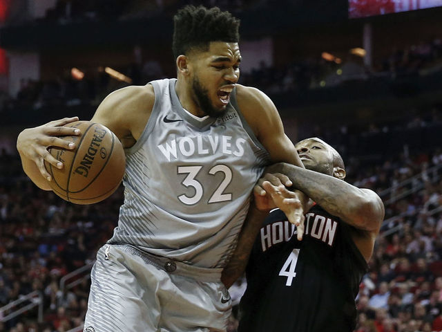 HOUSTON, TX - APRIL 15: Karl-Anthony Towns #32 of the Minnesota Timberwolves drives to the basket defended by PJ Tucker #4 of the Houston Rockets in the second half during Game One of the first round of the 2018 NBA Playoffs at Toyota Center on April 15, 2018 in Houston, Texas.