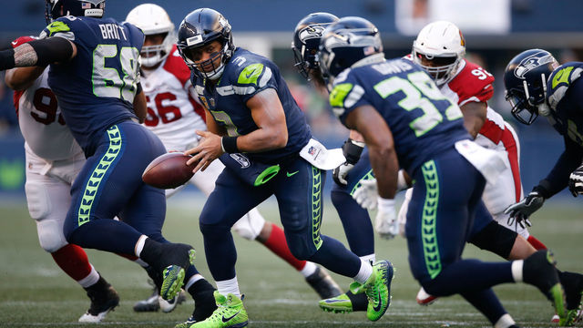 SEATTLE, WA - DECEMBER 31: Quarterback Russell Wilson #3 of the Seattle Seahawks looks to hand off the ball to Mike Davis #39 during the game against the Arizona Cardinals at CenturyLink Field on December 31, 2017 in Seattle, Washington.