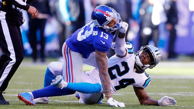 EAST RUTHERFORD, NJ - DECEMBER 20: (NEW YORK DAILIES OUT) Josh Norman #24 of the Carolina Panthers grabs the face mask of Odell Beckham #13 of the New York Giants during the first half on December 20, 2015 at MetLife Stadium in East Rutherford, New Jersey. The Panthers defeated the Giants 38-35.
