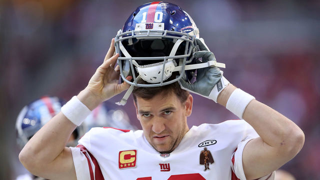 GLENDALE, AZ - DECEMBER 24: Quarterback Eli Manning #10 of the New York Giants puts on his helmet in the first half against the Arizona Cardinals at University of Phoenix Stadium on December 24, 2017 in Glendale, Arizona.
