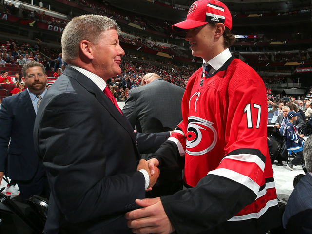 CHICAGO, IL - JUNE 24: Eetu Luostarinen meets with coach Bill Peters after being selected 42nd overall by the Carolina Hurricanes during the 2017 NHL Draft at the United Center on June 24, 2017 in Chicago, Illinois.