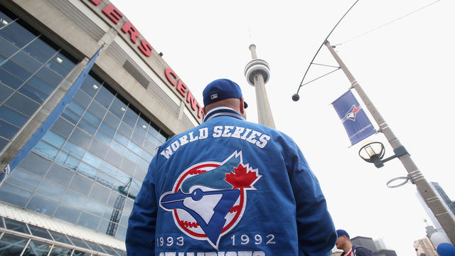 TORONTO, ON - OCTOBER 20: A fan waits outside the stadium before the game between the Kansas City Royals and the Toronto Blue Jays during game four of the American League Championship Series at Rogers Centre on October 20, 2015 in Toronto, Canada.