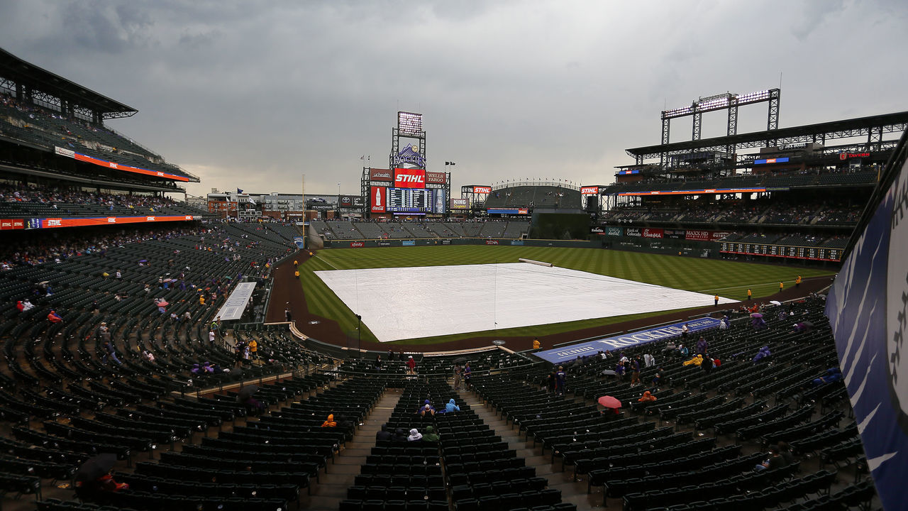 DENVER, CO - SEPTEMBER 17: The tarp sits on the field during a rain delay in the fifth inning of a regular season MLB game between the Colorado Rockies and the visiting San Diego Padres at Coors Field on September 17, 2017 in Denver, Colorado.