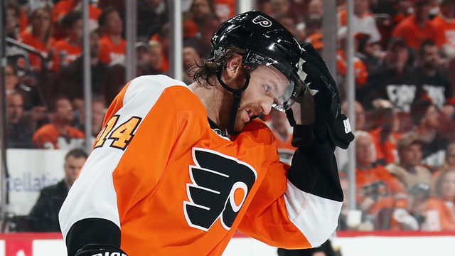 PHILADELPHIA, PA - APRIL 15: Sean Couturier #14 of the Philadelphia Flyers adjusts his helmet during the second period against the Pittsburgh Penguins in Game Three of the Eastern Conference First Round during the 2018 NHL Stanley Cup Playoffs at the Wells Fargo Center on April 15, 2018 in Philadelphia, Pennsylvania.
