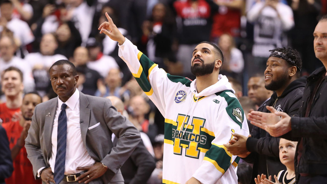 TORONTO, ON - APRIL 14: Rap artist Drake celebrates as head coach Dwane Casey of the Toronto Raptors looks on in the closing moments of their victory against the Washington Wizards in the first quarter during Game One of the first round of the 2018 NBA Playoffs at Air Canada Centre on April 14, 2018 in Toronto, Canada.