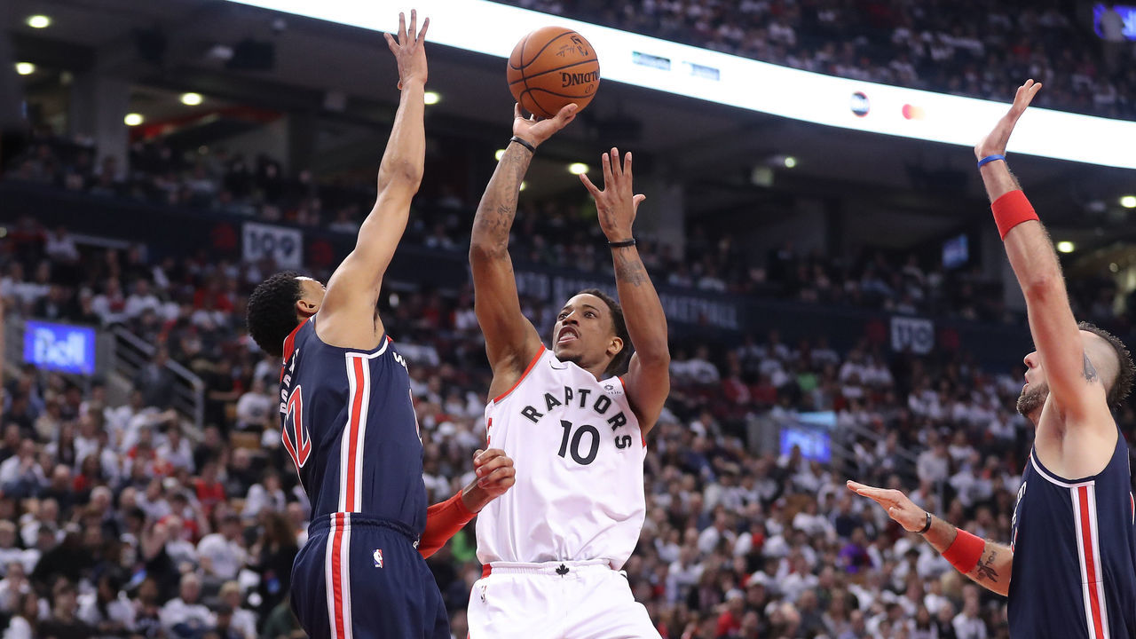 TORONTO, ON - APRIL 14: DeMar DeRozan #10 of the Toronto Raptors shoots and scores a basket over Otto Porter Jr. #22 of the Washington Wizards in the third quarter during Game One of the first round of the 2018 NBA Playoffs at Air Canada Centre on April 14, 2018 in Toronto, Canada.