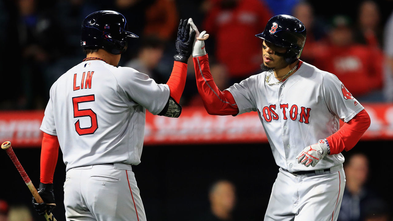ANAHEIM, CA - APRIL 17: Mookie Betts #50 is congratulated at the plate by Tzu-Wei Lin #5 of the Boston Red Sox after hitting a solo homerun during the eighth inning, his third of a game against the Los Angeles Angels of Anaheim at Angel Stadium on April 17, 2018 in Anaheim, California.