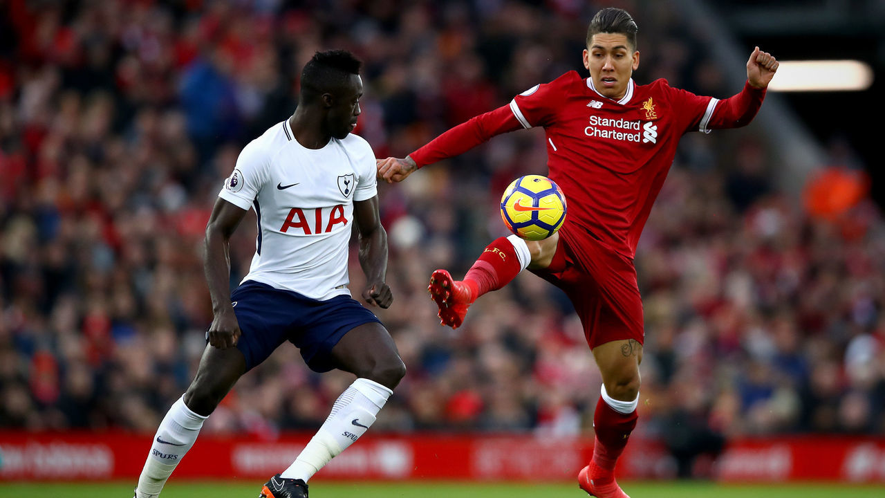 LIVERPOOL, ENGLAND - FEBRUARY 04: Roberto Firmino of Liverpool controls the ball under pressure from Davinson Sanchez of Tottenham Hotspur during the Premier League match between Liverpool and Tottenham Hotspur at Anfield on February 4, 2018 in Liverpool, England.