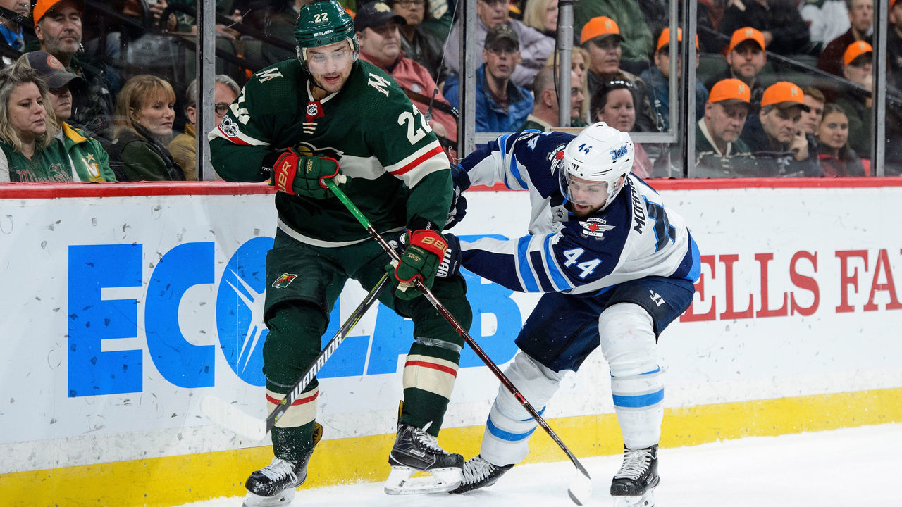 ST PAUL, MN - OCTOBER 31: Nino Niederreiter #22 of the Minnesota Wild and Josh Morrissey #44 of the Winnipeg Jets skate after the puck during the game on October 31, 2017 at Xcel Energy Center in St Paul, Minnesota. The Jets defeated the Wild 2-1.