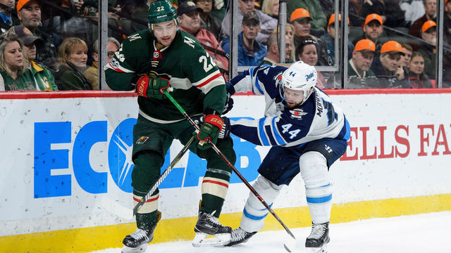 ST PAUL, MN - OCTOBER 31: Nino Niederreiter #22 of the Minnesota Wild and Josh Morrissey #44 of the Winnipeg Jets skate after the puck during the game on October 31, 2017 at Xcel Energy Center in St Paul, Minnesota. The Jets defeated the Wild 2-1.