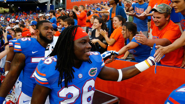 GAINESVILLE, FL - SEPTEMBER 06: Marcell Harris #26 of the Florida Gators celebrates with fans following the game against the Eastern Michigan Eagles at Ben Hill Stadium on September 6, 2014 in Gainesville, Florida.