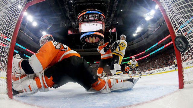 PHILADELPHIA, PA - APRIL 18: Brian Elliott #37 of the Philadelphia Flyers is unable to stop a shot from Evgeni Malkin of the Pittsburgh Penguins as Andrew MacDonald #47 of the Philadelphia Flyers and Sidney Crosby #87 of the Pittsburgh Penguins fight for position in the first period in Game Four of the Eastern Conference First Round during the 2018 NHL Stanley Cup Playoffs at Wells Fargo Center on April 18, 2018 in Philadelphia, Pennsylvania.