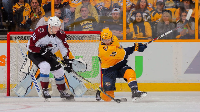 NASHVILLE, TN - APRIL 14: Ryan Hartman #38 of the Nashville Predators tries to clear a puck away from Carl Soderberg #34 of the Colorado Avalanche during the third period of a 5-4 Predators victory in Game Two of the Western Conference First Round during the 2018 NHL Stanley Cup Playoffs at Bridgestone Arena on April 14, 2018 in Nashville, Tennessee.