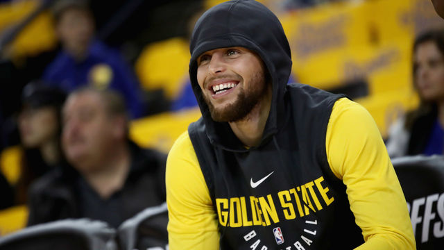 OAKLAND, CA - APRIL 16: Stephen Curry #30 of the Golden State Warriors sits on the bench before their game against the San Antonio Spurs in Game 2 of Round 1 of the 2018 NBA Playoffs at ORACLE Arena on April 16, 2018 in Oakland, California. Curry is still out with an injury.
