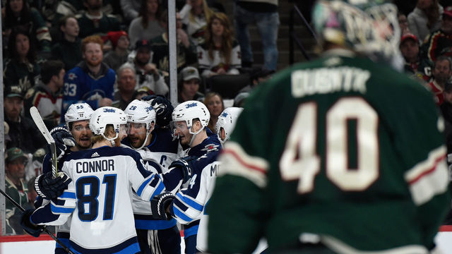 ST PAUL, MN - APRIL 17: The Winnipeg Jets celebrate a goal by teammate Mark Scheifele #55 as Devan Dubnyk #40 of the Minnesota Wild looks on during the first period in Game Four of the Western Conference First Round during the 2018 NHL Stanley Cup Playoffs at Xcel Energy Center on April 17, 2018 in St Paul, Minnesota.