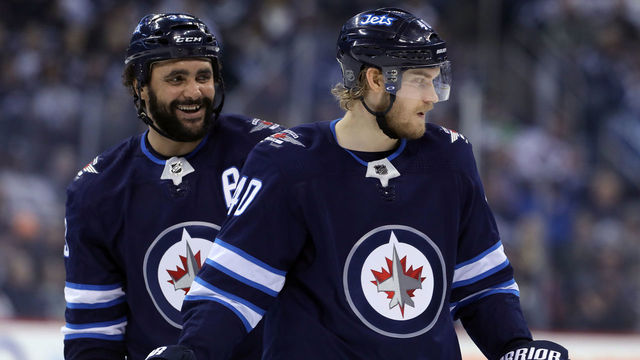 WINNIPEG, MANITOBA - APRIL 7: Dustin Byfuglien #33 and Joel Armia #40 of the Winnipeg Jets during NHL action against the Chicago Blackhawks on April 7, 2018 at Bell MTS Place in Winnipeg, Manitoba.