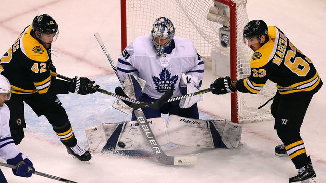 BOSTON, MA - APRIL 21: Boston Bruins David Backes, left, and Brad Marchand, right, attempt to get the puck past Toronto Maple Leafs goalie Frederik Andersen, center, late in the third period. The Boston Bruins host the Toronto Maple Leafs in Game 5 of the Eastern Conference First Round during the 2018 NHL Stanley Cup Playoffs at the TD Garden in Boston on April 21, 2018.