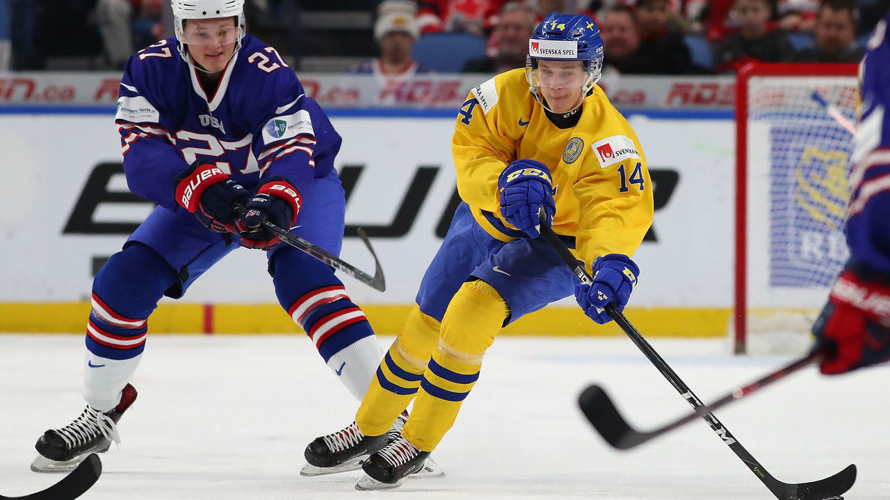 BUFFALO, NY - JANUARY 4: Riley Tufte #27 of United States pursues Elias Pettersson #14 of Sweden in the first period during the IIHF World Junior Championship at KeyBank Center on January 4, 2018 in Buffalo, New York.