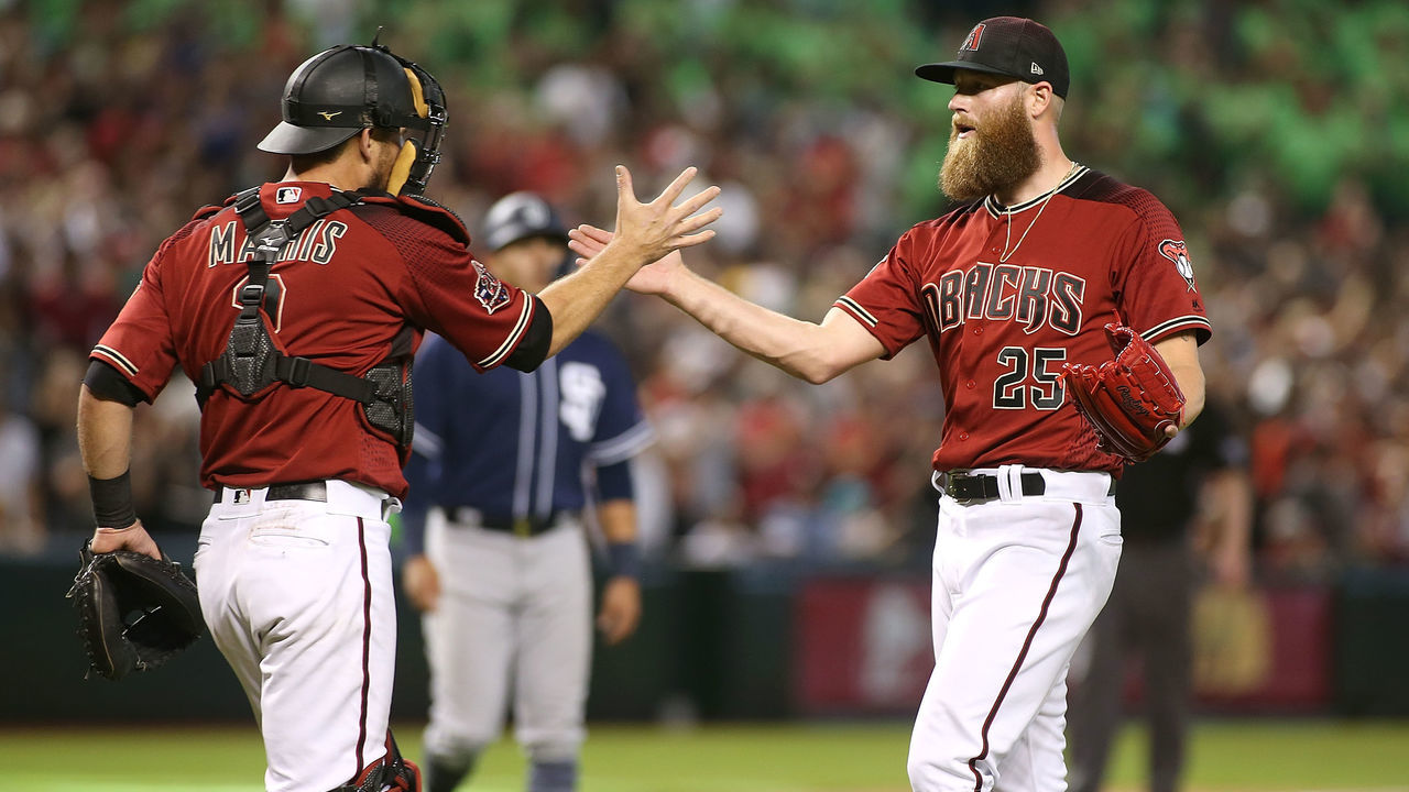 PHOENIX, AZ - APRIL 22: Archie Bradley #25 of the Arizona Diamondbacks is congratulated by catcher Jeff Mathis #2 after getting the final out to earning a save in a 4-2 victory against the San Diego Padres during an MLB game at Chase Field on April 22, 2018 in Phoenix, Arizona.