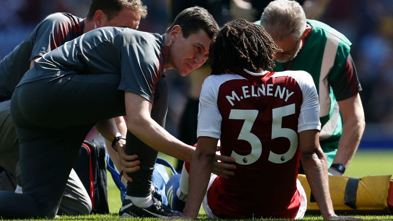 Arsenal's Egyptian midfielder Mohamed Elneny gets attention for an injury before being stretchered off during the English Premier League football match between Arsenal and West Ham United at the Emirates Stadium in London on April 22, 2018.
