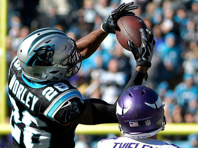 CHARLOTTE, NC - DECEMBER 10: Daryl Worley #26 of the Carolina Panthers intercepts the ball against Adam Thielen #19 of the Minnesota Vikings in the first quarter during their game at Bank of America Stadium on December 10, 2017 in Charlotte, North Carolina.