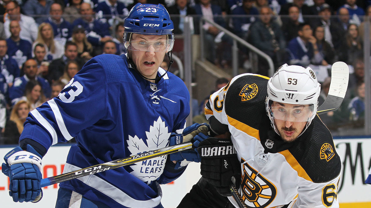 TORONTO, ON - APRIL 23: Brad Marchand #63 of the Boston Bruins battles against Travis Dermott #23 of the Toronto Maple Leafs in Game Six of the Eastern Conference First Round in the 2018 Stanley Cup Play-offs at the Air Canada Centre on April 23, 2018 in Toronto, Ontario, Canada.