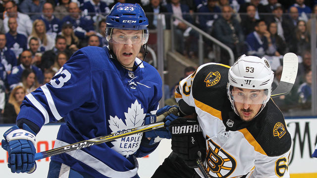 TORONTO, ON - APRIL 23: Brad Marchand #63 of the Boston Bruins battles against Travis Dermott #23 of the Toronto Maple Leafs in Game Six of the Eastern Conference First Round in the 2018 Stanley Cup Play-offs at the Air Canada Centre on April 23, 2018 in Toronto, Ontario, Canada.