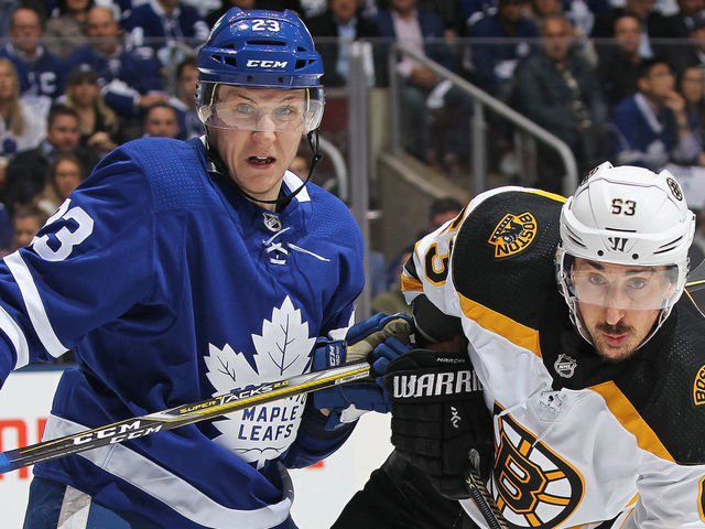 TORONTO, ON - APRIL 23: Brad Marchand #63 of the Boston Bruins battles against Travis Dermott #23 of the Toronto Maple Leafs in Game Six of the Eastern Conference First Round in the 2018 Stanley Cup Play-offs at the Air Canada Centre on April 23, 2018 in Toronto, Ontario, Canada.