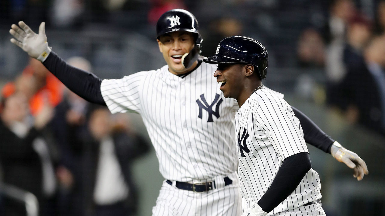 NEW YORK, NY - APRIL 16: Didi Gregorius #18 of the New York Yankees celebrates with teammate Giancarlo Stanton #27 after Gregorius drove them both home with a home run in the fourth inning against the Miami Marlins at Yankee Stadium on April 16, 2018 in the Bronx borough of New York City.