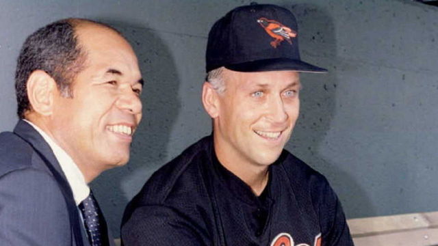 KANSAS CITY, : Former baseball player Sachio Kinugasa of Japan (L) and Cal Ripken of the Baltimore Orioles (R) pose for photographers before the Orioles meet the Kansas City Royals at Kauffman Stadium in Kansas City 13 June. In the 13 June game, Ripken will tie Kinugasa's record of 2215 consecutive games played, and will break it 14 June. Kinugasa was with the Hiroshima Carp of the Japanese Central League. AFP PHOTO/Paul BUCK