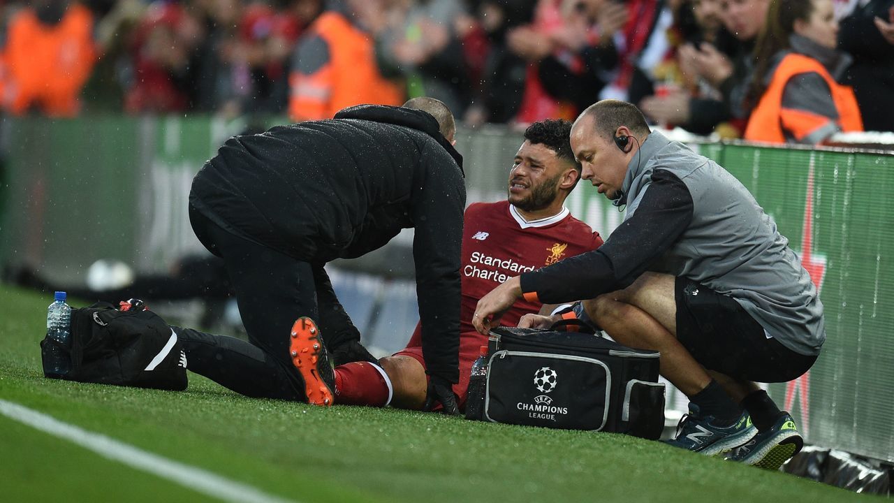 Liverpool's English midfielder Alex Oxlade-Chamberlain (C) picks up an injury during the UEFA Champions League first leg semi-final football match between Liverpool and Roma at Anfield stadium in Liverpool, north west England on April 24, 2018.
