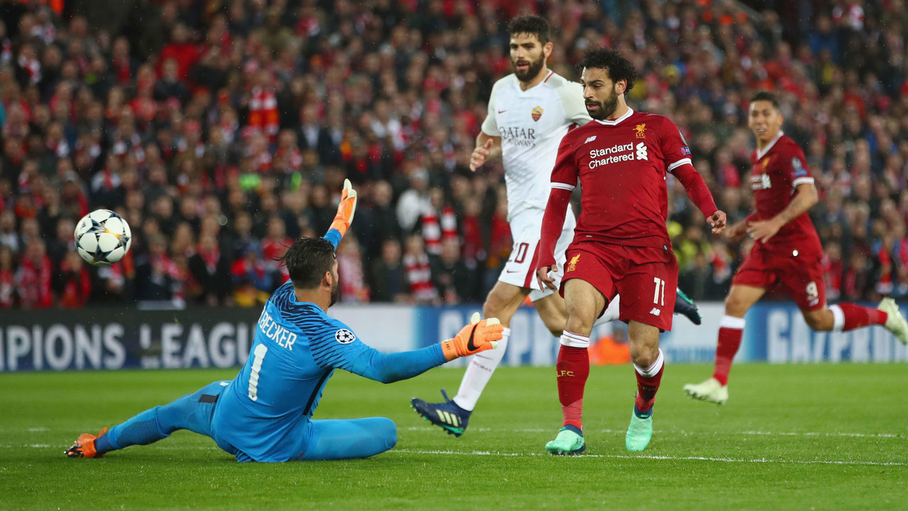 LIVERPOOL, ENGLAND - APRIL 24: Mohamed Salah of Liverpool scores his sides second goal past Alisson Becker of AS Roma during the UEFA Champions League Semi Final First Leg match between Liverpool and A.S. Roma at Anfield on April 24, 2018 in Liverpool, United Kingdom.