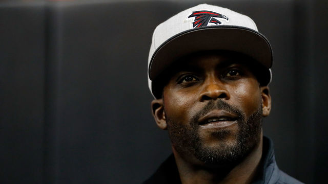 ATLANTA, GA - JANUARY 01: Former Atlanta Falcons player Michael Vick walks on the field prior to the game against the New Orleans Saints at the Georgia Dome on January 1, 2017 in Atlanta, Georgia.