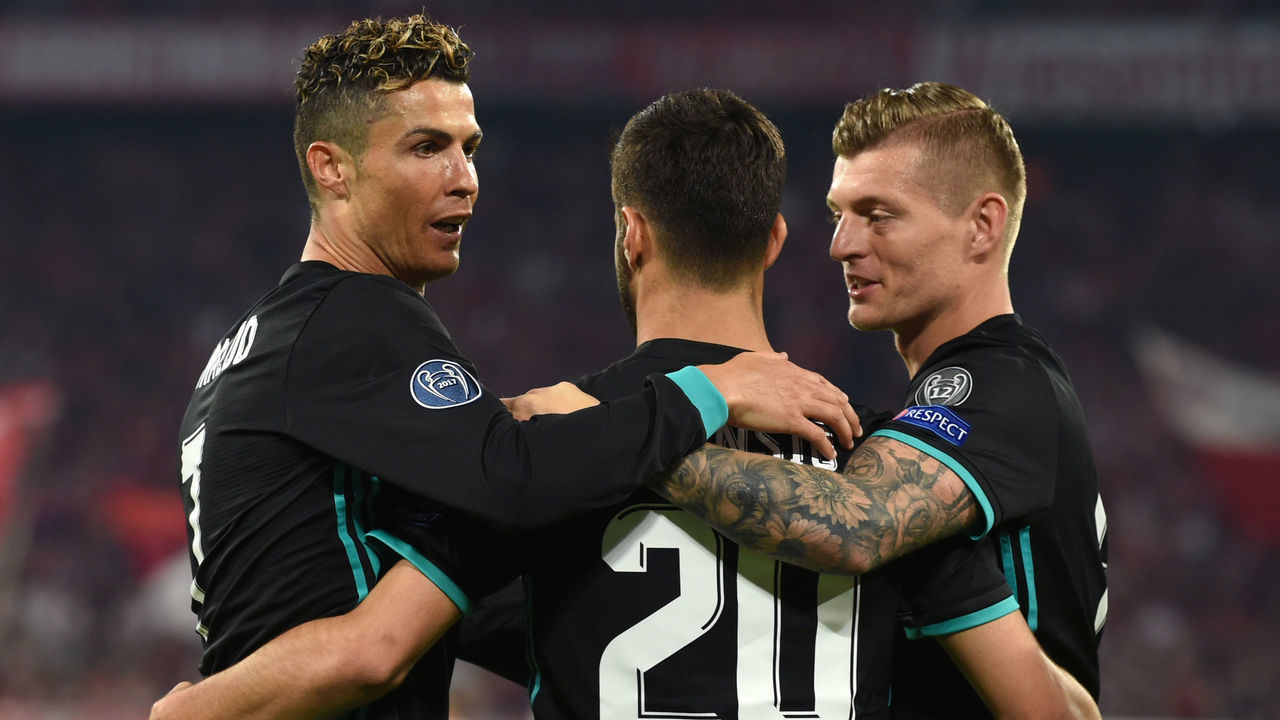 Real Madrid's Spanish midfielder Marco Asensio (C) celebrates with Real Madrid's Portuguese forward Cristiano Ronaldo (L) and Real Madrid's German midfielder Toni Kroos after scoring a goal during the UEFA Champions League semi-final first-leg football match FC Bayern Munich v Real Madrid CF in Munich in southern Germany on April 25, 2018.