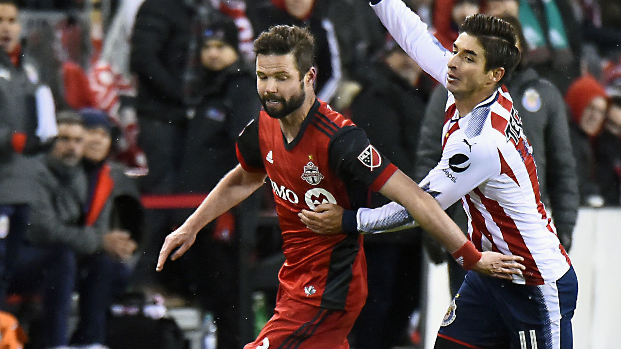 TORONTO, ON - APRIL 17: Drew Moor #3 of Toronto FC controls the ball past Isac Brizuela #11 of Chivas Guadalajara during the CONCACAF Champions League Final Leg 1 on April 17, 2018 at BMO Field in Toronto, Ontario, Canada.
