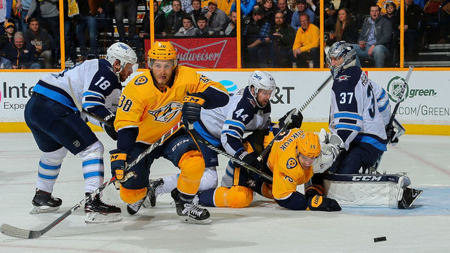 NASHVILLE, TN - MARCH 13: Ryan Hartman #38 and Calle Jarnkrok #19 of the Nashville Predators fight against Bryan Little #18 and Josh Morrissey #44 of the Winnipeg Jets in front of goalie Connor Hellebuyck #37 during the first period at Bridgestone Arena on March 13, 2018 in Nashville, Tennessee.