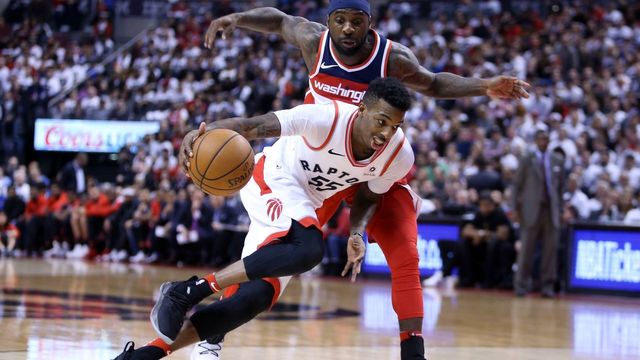 TORONTO, ON - APRIL 25: Delon Wright #55 of the Toronto Raptors dribbles the ball as Ty Lawson #4 of the Washington Wizards defends during the second half of Game Five in Round One of the 2018 NBA playoffs at Air Canada Centre on April 25, 2018 in Toronto, Canada.