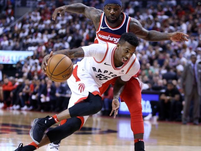 TORONTO, ON - APRIL 25: Delon Wright #55 of the Toronto Raptors dribbles the ball as Ty Lawson #4 of the Washington Wizards defends during the second half of Game Five in Round One of the 2018 NBA playoffs at Air Canada Centre on April 25, 2018 in Toronto, Canada.
