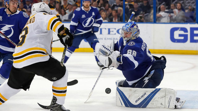 TAMPA, FL - APRIL 3: Andrei Vasilevskiy #88 of the Tampa Bay Lightning makes a save as Brad Marchand #63 of the Boston Bruins looks for a rebound during the third period of the game at the Amalie Arena on April 3, 2018 in Tampa, Florida.