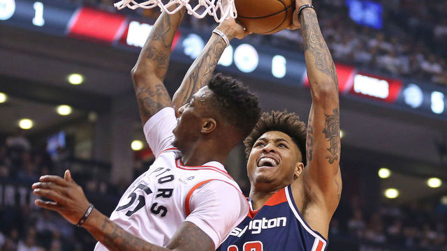 TORONTO, ON - APRIL 17: Kelly Oubre Jr. #4 of the Washington Wizards goes up and over Delon Wright #55 of the Toronto Raptors for a basket in Game Two of the Eastern Conference First Round in the 2018 NBA Play-offs at the Air Canada Centre on April 17, 2018 in Toronto, Ontario, Canada. The Raptors defeated the Wizards 130-119.