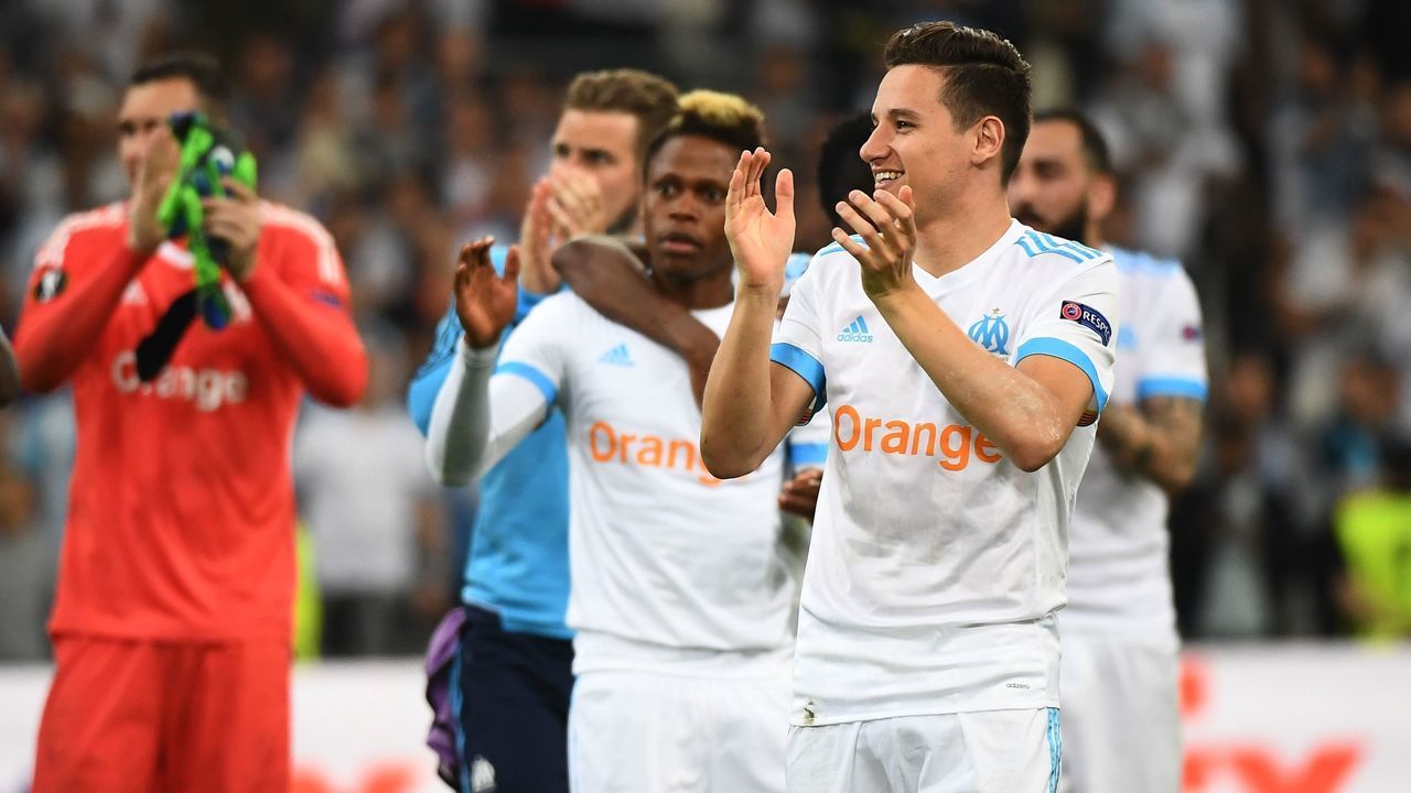 Marseille's French midfielder Florian Thauvin (R) and team mates celebrate their victory at the end of the UEFA Europa League first-leg semi-final football match between Olympique de Marseille and FC Salzburg at the Velodrome Stadium in Marseille, southeastern France, on April 26, 2018.