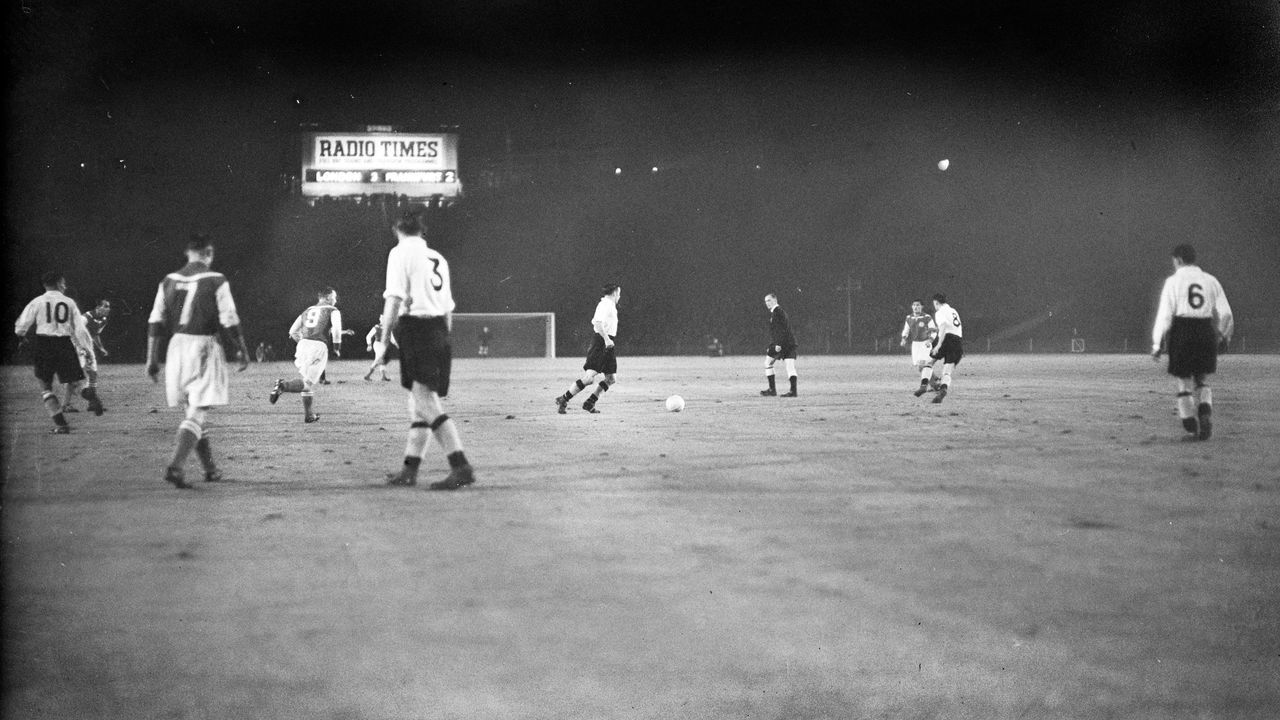 Action during the first match at Wembley to be played under floodlights.
