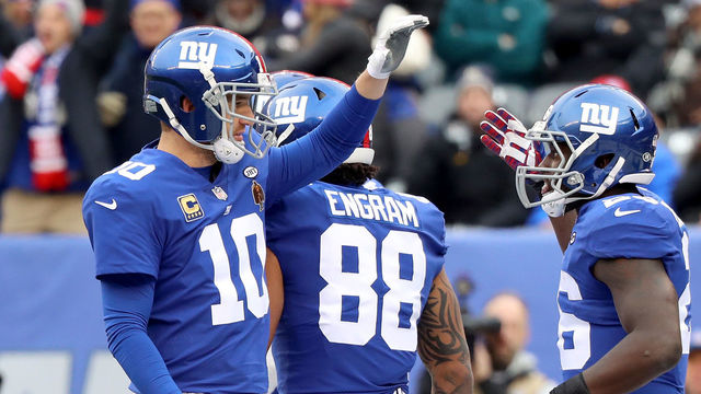 EAST RUTHERFORD, NJ - DECEMBER 17: Orleans Darkwa #26 of the New York Giants celebrates with Eli Manning #10 after scoring a one yard touchdown against the Philadelphia Eagles during the first quarter in the game at MetLife Stadium on December 17, 2017 in East Rutherford, New Jersey.