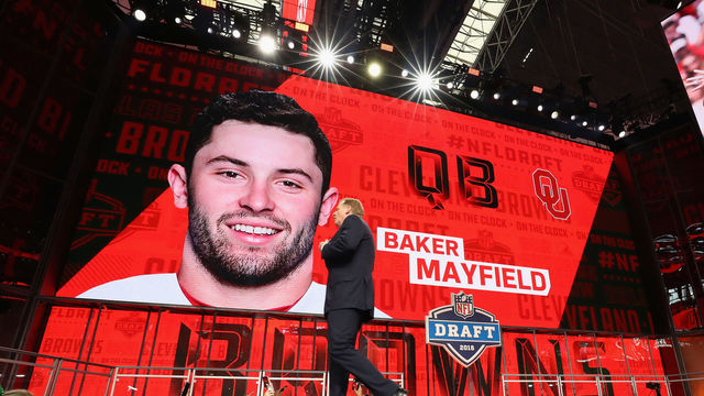 ARLINGTON, TX - APRIL 26: NFL Commissioner Roger Goodell walks past a video board displaying an image of Baker Mayfield of Oklahoma after he was picked #1 overall by the Cleveland Browns during the first round of the 2018 NFL Draft at AT&T Stadium on April 26, 2018 in Arlington, Texas.