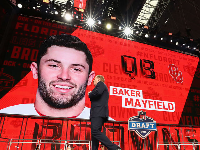 ARLINGTON, TX - APRIL 26: NFL Commissioner Roger Goodell walks past a video board displaying an image of Baker Mayfield of Oklahoma after he was picked #1 overall by the Cleveland Browns during the first round of the 2018 NFL Draft at AT&T Stadium on April 26, 2018 in Arlington, Texas.