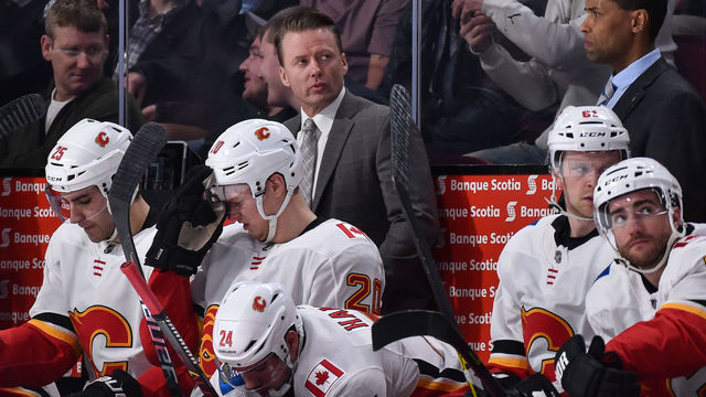 MONTREAL, QC - DECEMBER 07: Head coach of the Calgary Flames Glen Gulutzan looks on from behind the bench against the Montreal Canadiens during the NHL game at the Bell Centre on December 7, 2017 in Montreal, Quebec, Canada. The Calgary Flames defeated the Montreal Canadiens 3-2 in overtime.