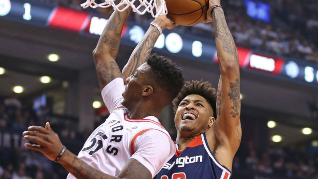 TORONTO, ON - APRIL 17: Kelly Oubre Jr. #4 of the Washington Wizards goes up and over Delon Wright #55 of the Toronto Raptors for a basket in Game Two of the Eastern Conference First Round in the 2018 NBA Play-offs at the Air Canada Centre on April 17, 2018 in Toronto, Ontario, Canada. The Raptors defeated the Wizards 130-119.