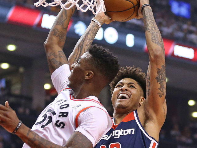 TORONTO, ON - APRIL 17: Kelly Oubre Jr. #4 of the Washington Wizards goes up and over Delon Wright #55 of the Toronto Raptors for a basket in Game Two of the Eastern Conference First Round in the 2018 NBA Play-offs at the Air Canada Centre on April 17, 2018 in Toronto, Ontario, Canada. The Raptors defeated the Wizards 130-119.