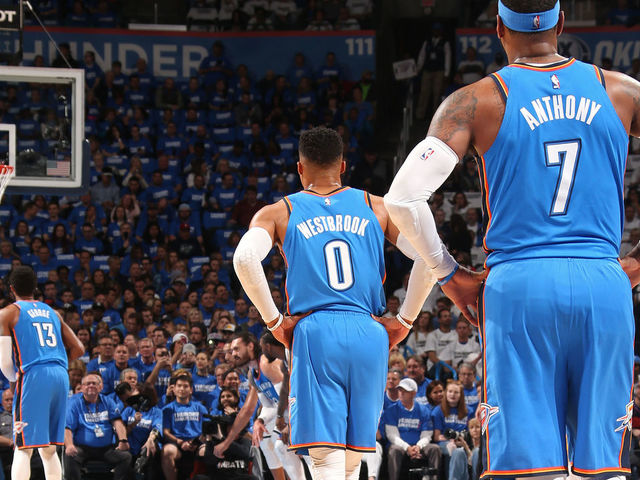 OKLAHOMA CITY, OK - APRIL 25: Carmelo Anthony #7 of the Oklahoma City Thunder and Russell Westbrook #0 of the Oklahoma City Thunder look on as Paul George #13 of the Oklahoma City Thunder shoots the ball against the Utah Jazz in Game Five of Round One of the 2018 NBA Playoffs on April 25, 2018 at Chesapeake Energy Arena in Oklahoma City, Oklahoma. Mandatory Copyright Notice: Copyright 2018 NBAE